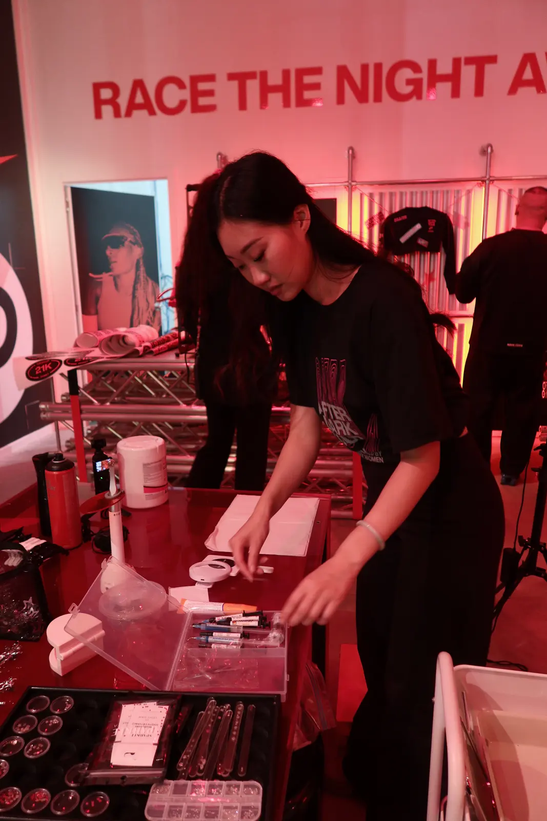 The artist laying out the gem kit at the pop-up station