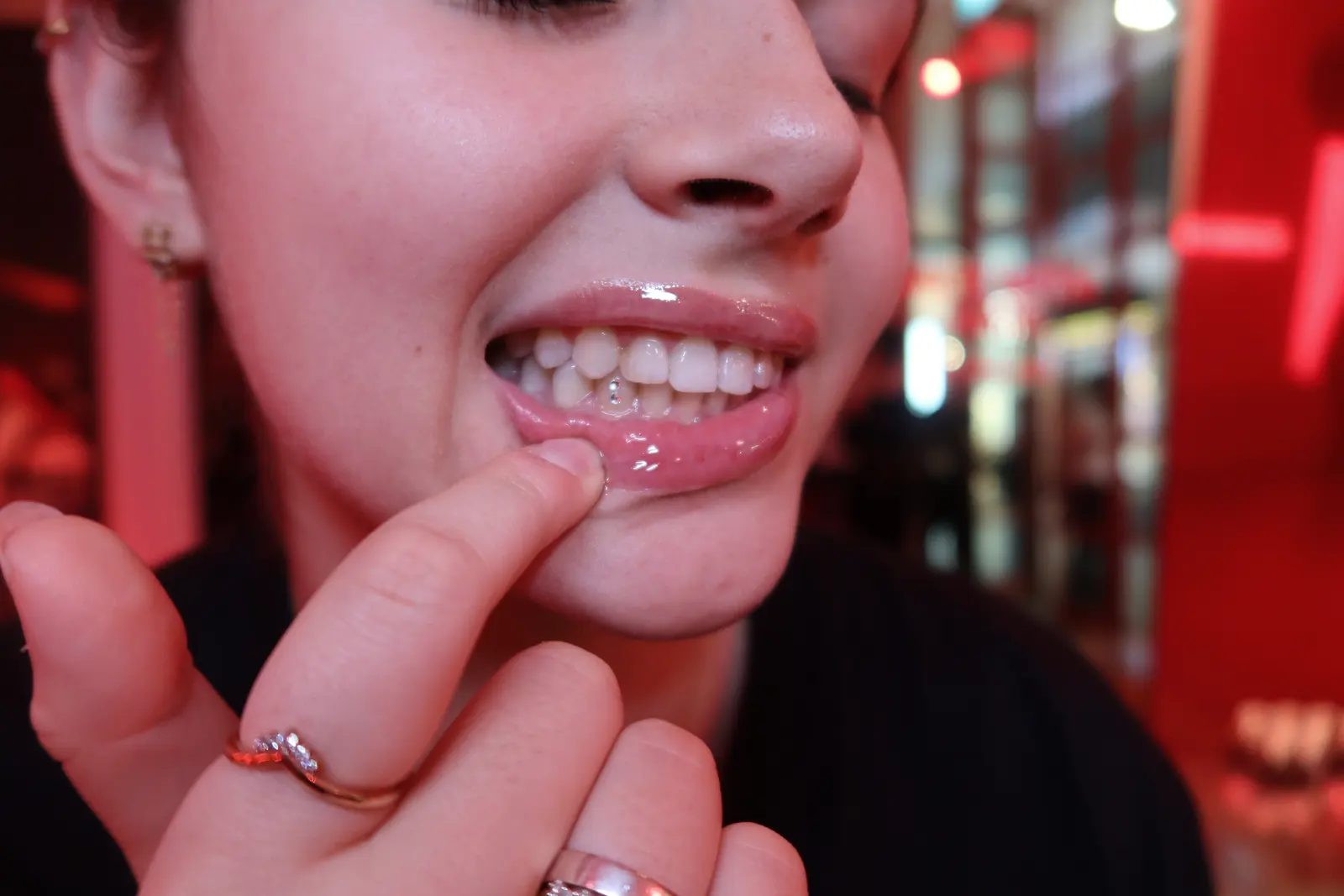 Close-up of a fresh tooth gem on a smiling client