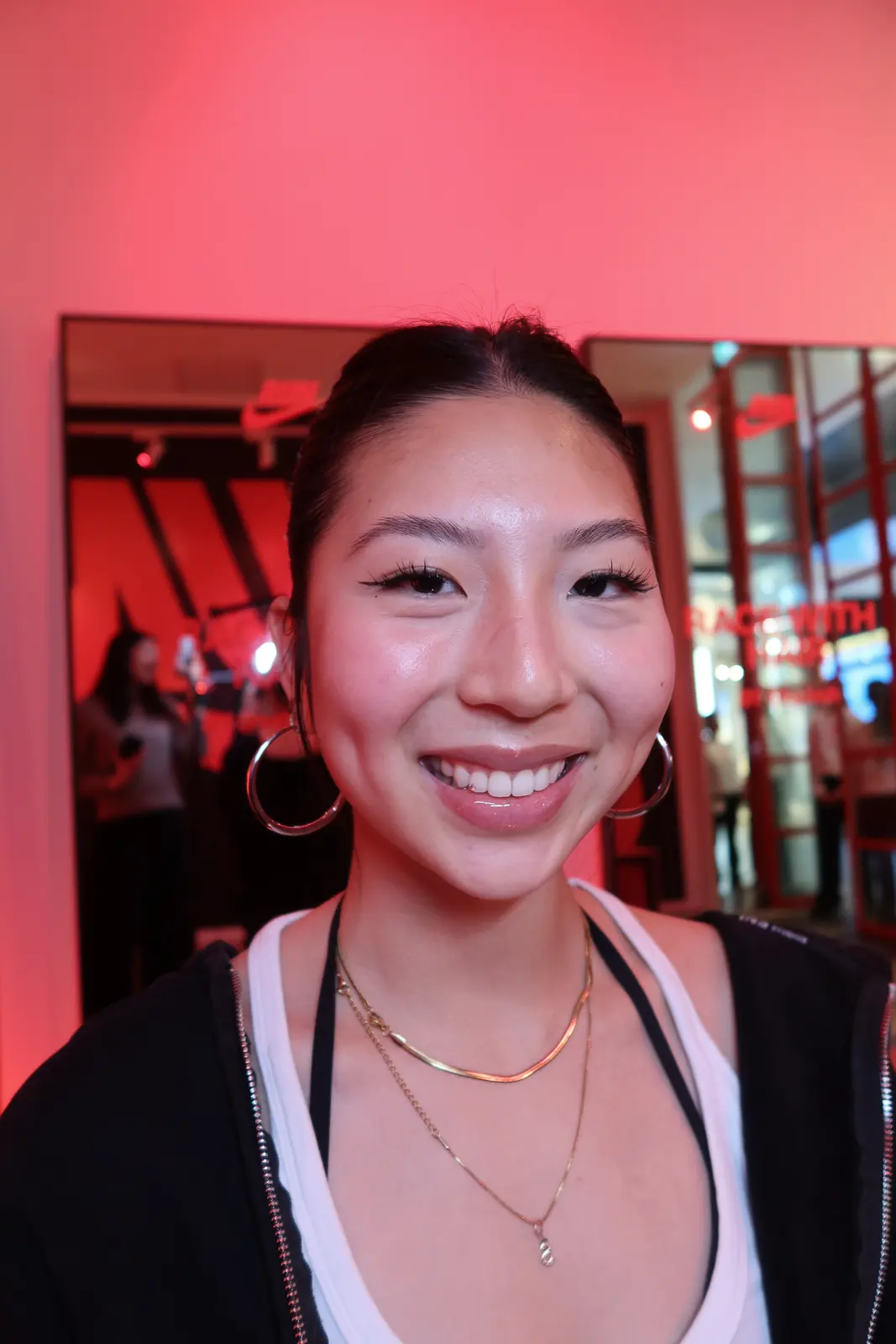 A client smiling at the camera under red event light