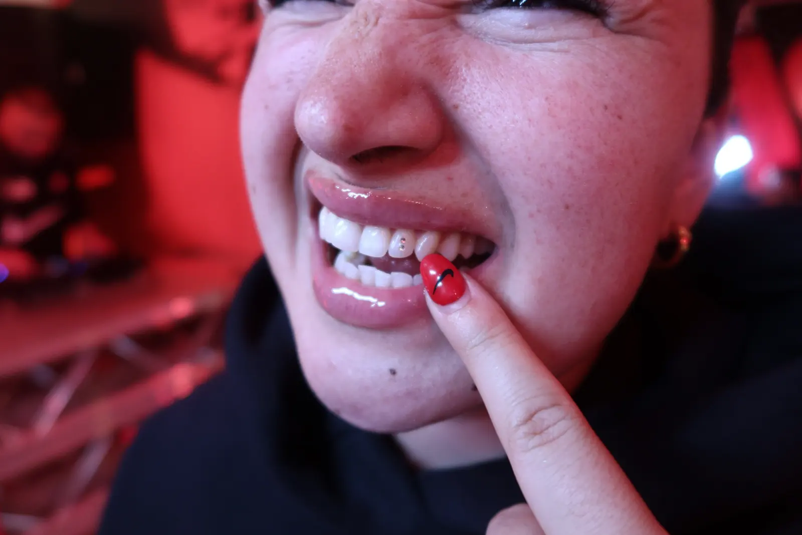 A gem shown off with red-painted nails