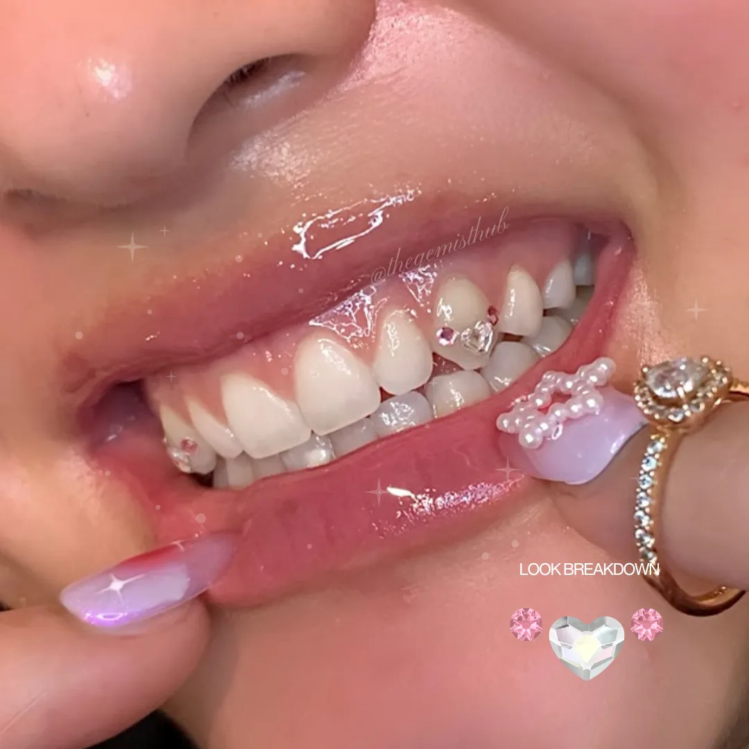 A heart-shaped crystal charm set between two round gems